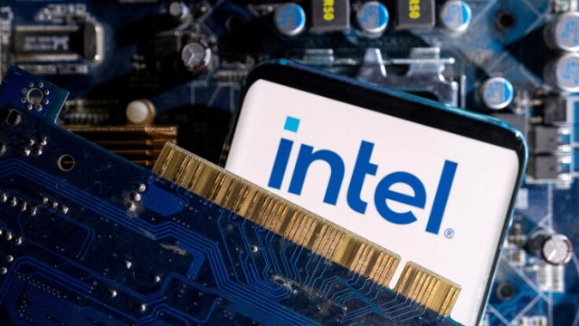 A smartphone with a displayed Intel logo is placed on a computer motherboard in this illustration